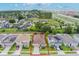 Aerial view of a home in a residential area highlighting solar panels on the roof at 245 Bella Verano Way, Davenport, FL 33897