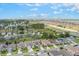 Expansive aerial view of a well-planned community with green spaces, single-Gathering homes, and convenient highway access at 245 Bella Verano Way, Davenport, FL 33897