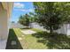 Backyard with a privacy fence, mature trees, and a patio space at 245 Bella Verano Way, Davenport, FL 33897
