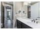 Bathroom vanity featuring quartz countertop and modern faucet with view down hallway at 245 Bella Verano Way, Davenport, FL 33897