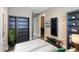 Bedroom featuring bookshelves, mounted TV, and doorway to laundry room at 245 Bella Verano Way, Davenport, FL 33897
