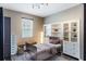 Bedroom with a metal frame bed and display shelves with a window view at 245 Bella Verano Way, Davenport, FL 33897