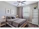 Bedroom with a ceiling fan, neutral decor, and matching bedside tables at 245 Bella Verano Way, Davenport, FL 33897