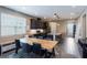Bright dining area adjacent to the kitchen, featuring a large window and a contemporary dining table set at 245 Bella Verano Way, Davenport, FL 33897