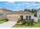 Charming single-story home features a two-car garage, landscaped front yard, and stone accents on the facade at 245 Bella Verano Way, Davenport, FL 33897
