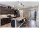 Modern kitchen features granite countertops, stainless steel appliances, a large island, and stylish lighting fixtures at 245 Bella Verano Way, Davenport, FL 33897