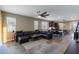 Spacious living room with hardwood floors, large windows, and an open layout connecting to the kitchen and dining area at 245 Bella Verano Way, Davenport, FL 33897