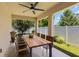 Covered back porch with ceiling fan, wood table and matching chairs at 245 Bella Verano Way, Davenport, FL 33897