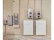 Utility room featuring wall-mounted Tesla power storage batteries and electrical panel at 245 Bella Verano Way, Davenport, FL 33897