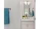 Bathroom with a white cabinet, mirror, and towel rack at 2607 Lafayette Ave, Winter Park, FL 32789