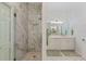 Modern bathroom showcasing a glass-enclosed shower, white marble tile, and a double vanity at 2607 Lafayette Ave, Winter Park, FL 32789