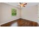 A simple bedroom with wood floors and a window with blinds at 2607 Lafayette Ave, Winter Park, FL 32789