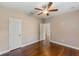 Bedroom features wood floors, a ceiling fan, and a doorway leading to another room at 2607 Lafayette Ave, Winter Park, FL 32789