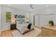 Bright bedroom with hardwood floors, ceiling fan, and two windows at 2607 Lafayette Ave, Winter Park, FL 32789