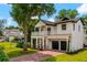 Charming two-story home features a manicured lawn, brick driveway, and inviting front porch with second-story balcony at 2607 Lafayette Ave, Winter Park, FL 32789