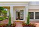 Inviting front porch with chairs, brick flooring, and meticulously maintained landscaping creates an appealing entrance at 2607 Lafayette Ave, Winter Park, FL 32789