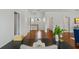 A bright hallway with hardwood floors leading to multiple rooms at 2607 Lafayette Ave, Winter Park, FL 32789