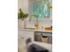 Bright kitchen features white cabinets, stainless steel appliances, gold fixtures, and a large window at 2607 Lafayette Ave, Winter Park, FL 32789