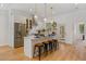 Modern kitchen with stainless steel appliances, island seating, and bright open floorplan at 2607 Lafayette Ave, Winter Park, FL 32789