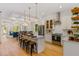 Open kitchen featuring stainless steel appliances, island with seating, hardwood floors, and open layout at 2607 Lafayette Ave, Winter Park, FL 32789