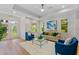 Cozy living room with hardwood floors, comfortable seating, and sun-filled windows at 2607 Lafayette Ave, Winter Park, FL 32789