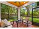 Enclosed patio with comfortable seating and view of lush landscaping at 2607 Lafayette Ave, Winter Park, FL 32789
