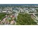 Wide angle aerial view of community including green space, road access, and nearby lake at 2636 Crown Ct, Kissimmee, FL 34741