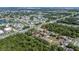Wide angle aerial view of community including green space, road access, and nearby lake at 2636 Crown Ct, Kissimmee, FL 34741