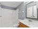 Cozy bathroom featuring a tub-shower combination and a decorative mirror at 2636 Crown Ct, Kissimmee, FL 34741