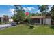 Exterior view of building featuring mature landscaping, parking, and partial fence at 2636 Crown Ct, Kissimmee, FL 34741