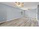 Bright, open living room with neutral paint, ceiling fans, and wood-look flooring at 2636 Crown Ct, Kissimmee, FL 34741