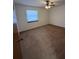 Bedroom with neutral carpet, large window, and ceiling fan at 2842 Blind Owl Dr, Orlando, FL 32822