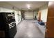 Spacious two-car garage offering ample room for parking and storage, with a refrigerator at 2842 Blind Owl Dr, Orlando, FL 32822