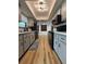 Galley kitchen with modern cabinets, stainless appliances, and wood-look flooring at 2842 Blind Owl Dr, Orlando, FL 32822