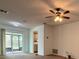 Bright living room featuring a ceiling fan and sliding doors to the screened in porch at 2842 Blind Owl Dr, Orlando, FL 32822