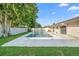 Residential backyard with a private in-ground pool, manicured lawn, and neutral-toned home exterior at 2871 Milstead St, Orlando, FL 32837