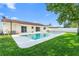 Private backyard featuring a sparkling pool, well-maintained lawn, and the home's exterior with sliding glass doors at 2871 Milstead St, Orlando, FL 32837