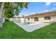 Residential backyard with a private in-ground pool, lush lawn, and the home's exterior with sliding glass doors at 2871 Milstead St, Orlando, FL 32837