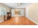 Bedroom featuring hardwood floors, a ceiling fan, and a view into the kitchen at 2871 Milstead St, Orlando, FL 32837