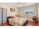 Bedroom with a quilt bedspread, dark wood floors, and large windows for ample natural light at 2871 Milstead St, Orlando, FL 32837
