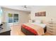 Bedroom with sliding glass doors with pool view, neutral color scheme and ceiling fan at 2871 Milstead St, Orlando, FL 32837