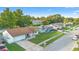 The exterior view of these well-maintained homes features lush landscaping, a long driveway, and a blue sky at 2871 Milstead St, Orlando, FL 32837