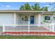 Charming home featuring a white picket fence, well-maintained lawn, and inviting entrance at 2871 Milstead St, Orlando, FL 32837