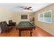 Spacious game room with a billiard table, comfortable leather chairs and warm lighting at 2871 Milstead St, Orlando, FL 32837