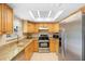 Bright kitchen featuring granite countertops, stainless steel appliances, and a skylight at 2871 Milstead St, Orlando, FL 32837