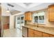 Well-lit kitchen featuring granite countertops, stainless steel dishwasher, and sliding glass door to backyard at 2871 Milstead St, Orlando, FL 32837