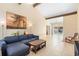 Spacious living room boasts a high ceiling with wood beams, tile flooring, and ample natural light at 2871 Milstead St, Orlando, FL 32837