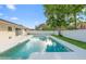 Backyard swimming pool with concrete patio, green lawn, and the home's exterior, offering a relaxing retreat at 2871 Milstead St, Orlando, FL 32837