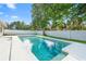 Backyard pool surrounded by trees, landscaping, and privacy fence, offering a serene outdoor space at 2871 Milstead St, Orlando, FL 32837