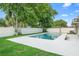 Backyard pool with a freshly painted deck and a white fence at 2871 Milstead St, Orlando, FL 32837